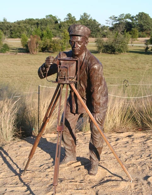 A bronze sculpture of John Daniels located at the Wright Brothers Memorial