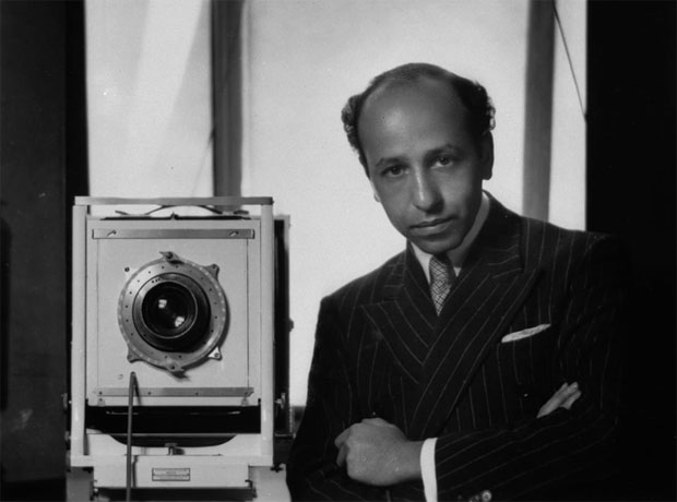 Yousuf Karsh standing next to his camera in a self portrait